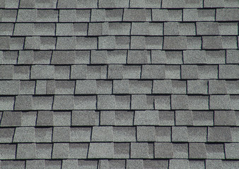 The roof is covered with soft tiles in the form of geometric plates