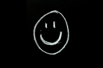 smiling face drawn on chalkboard
