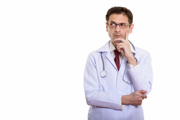 Studio shot of young man doctor wearing eyeglasses while thinkin