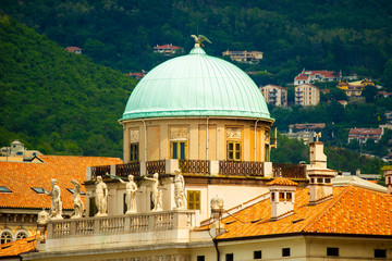 Carciotti palace, Trieste, Italy. The dome and part of the facade and hills in background