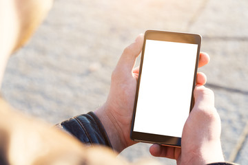 Man uses his Mobile Phone outdoor, close up.