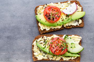Sandwiches with cream cheese, vegetables and salami.