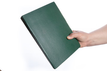 Woman's hand is holding  book.