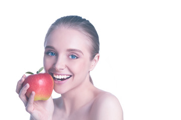 Portrait of happy smiling young beautiful woman eating red apple, over white background