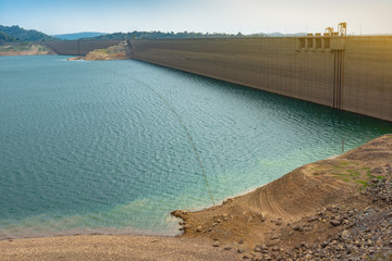 The very low water level above the dam due to a shortage of water from abnormally rainfall