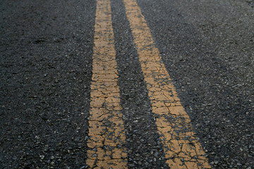 Obraz premium Background of two yellow line crack on asphalt road.
