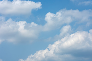 White clouds in the blue sky on a bright day