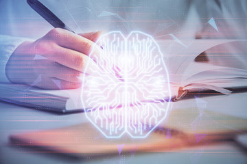 Double exposure of woman's writing hand on background with brain hologram. Concept of brainstorming.