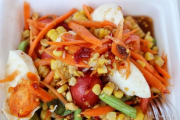  Spicy vegetable salad mixed with salted eggs and corn, papaya salad, fruit
