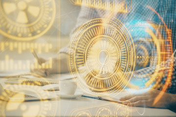 Technology theme hologram with man working on computer on background. High tech concept. Double exposure.