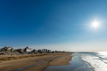 Sunny day on North sea beach in Netherlands in Schegeningen, tourist and vacation destination in Europe