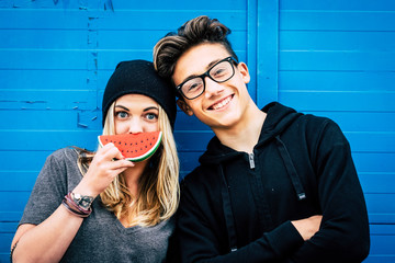 couple of teenagers enjoying and have fun together - relationship concept - guy with glasses and...