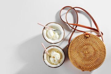 Bamboo bag and ice cream in half of coconut. Summer Vacation concept.