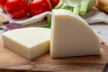 Italian cheese, Provolone dolce cow cheese from Cremona served with olive bread and tomatoes