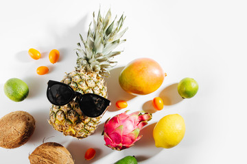 Tropical fruit and  pineapple in sunglasses . Summer tropical concept.