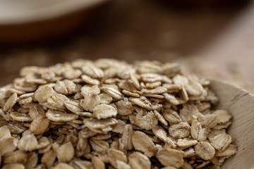 Closeup of oat flakes in a bamboo bowl