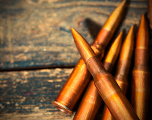 Still life with five rifle cartridges