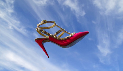 Pink shoes floating in the sky.