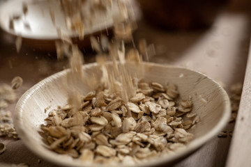 Falling oat flakes in bowl