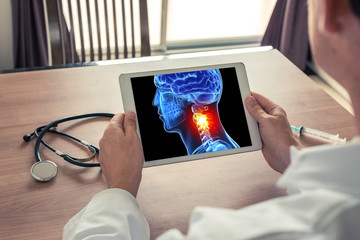 Doctor holding a digital tablet with x-ray of 3D head and pain in the neck. Migraine and headache...