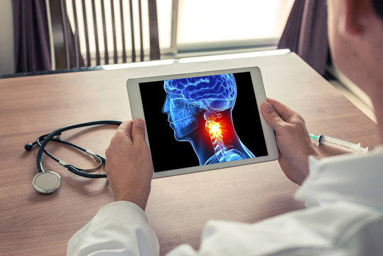 Doctor holding a digital tablet with x-ray of 3D head and pain in the neck. Migraine and headache concept