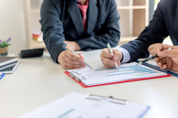 Businessman present graph financial information at the meeting.