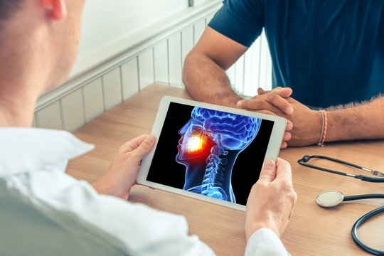 Doctor or dentist holding a digital tablet with x-ray of the 3D head of the patient with pain on the teeth of the patient