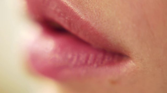 Beautiful woman lips with lipstick. Red lip. Makeup artist applies red lipstick. Beauty girl makeup.