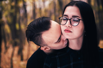 young man and woman in the autumn forest