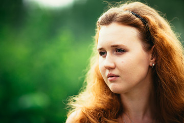 Fototapeta premium portrait of a girl against a nature background