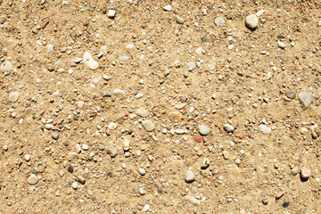 Sandy yellow rocky road texture. Natural earth path backdrop.