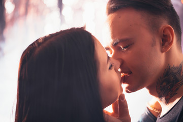 guy and the girl kiss closeup on a light background.