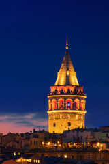 Fototapeta na wymiar Illuminated Galata Tower in Istanbul, Turkey with dark blue sky