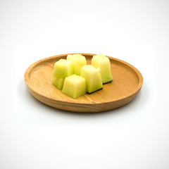 Cantaloupe Melon, In a wooden plate with green flesh on the White Blackground.