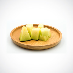 Cantaloupe Melon, In a wooden plate with green flesh on the White Blackground.