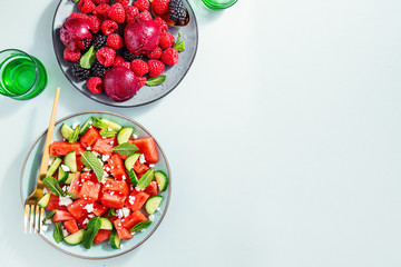 Summer salads with watermelon and cucumbers, berries and ice cream