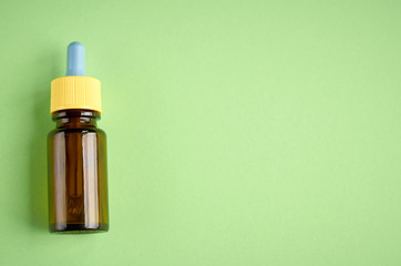 Nasal drops bottle composition, glass bottle green background