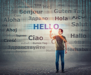 Student guy pointing index finger up choosing word hello with different translations. Multilingual...