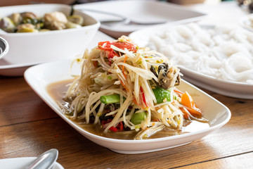 The lunch of Thai food papaya salad,Som Tum,spicy flavor and noodles on the table.