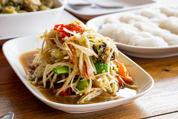 The lunch of Thai food papaya salad,Som Tum,spicy flavor and noodles on the table.