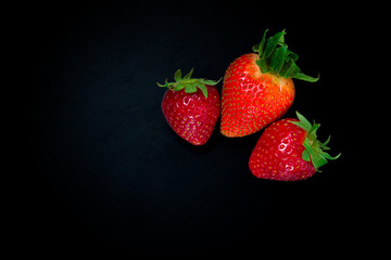 strawberry berries on a black background. From above. Isolated on black