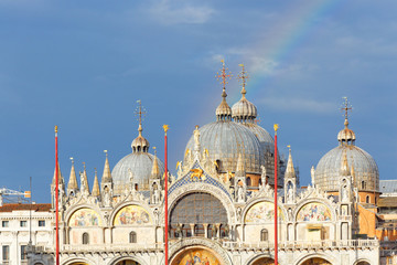Fototapeta na wymiar Rainbow over the basilica called 'San Marco' in Venice, Italy