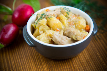 stewed potatoes with vegetables, cabbage and meat in a bowl
