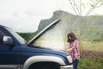 Woman with broken car on the country road