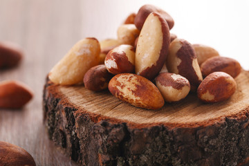 Tasty brasil nuts on wooden background. closeup