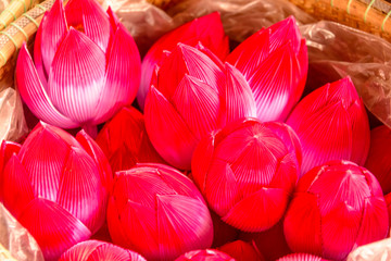Paper lotus flowers in a basket for sale in Hue, Vietnam.
