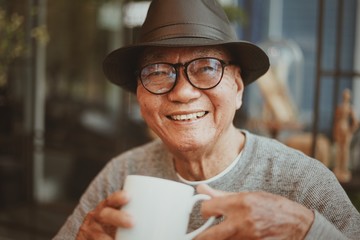 Portrait of senior man drinking coffee in cafe