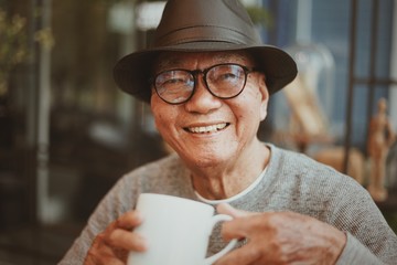 Portrait of senior man drinking coffee in cafe - Powered by Adobe