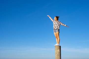 girl in balance on top of the mountain