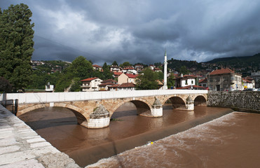 Sarajevo, Bosnia: skyline of the city seen from Seher-Cehajina cuprija, the stone pedestrian bridge...